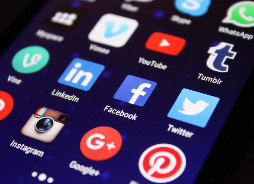 Social media icons connecting to a small business website on desktop and mobile screens