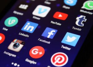 Social media icons connecting to a small business website on desktop and mobile screens