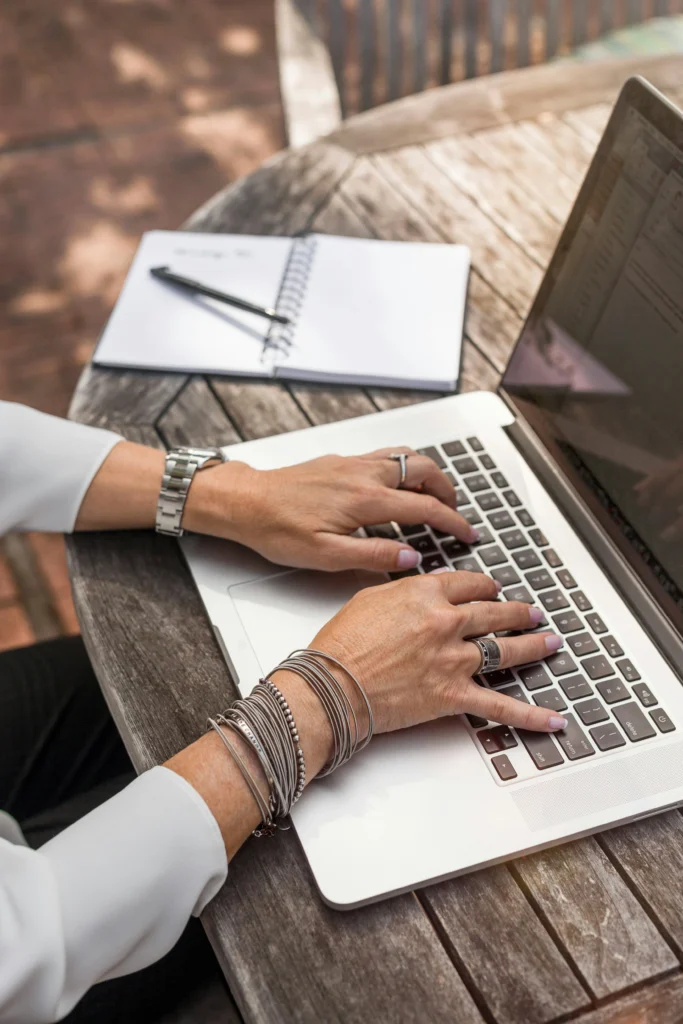Woman typing content on a laptop — what to write for your website as a small business owner