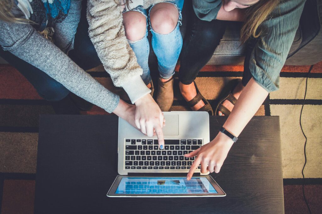 Website user clicking call-to-action button on laptop screen