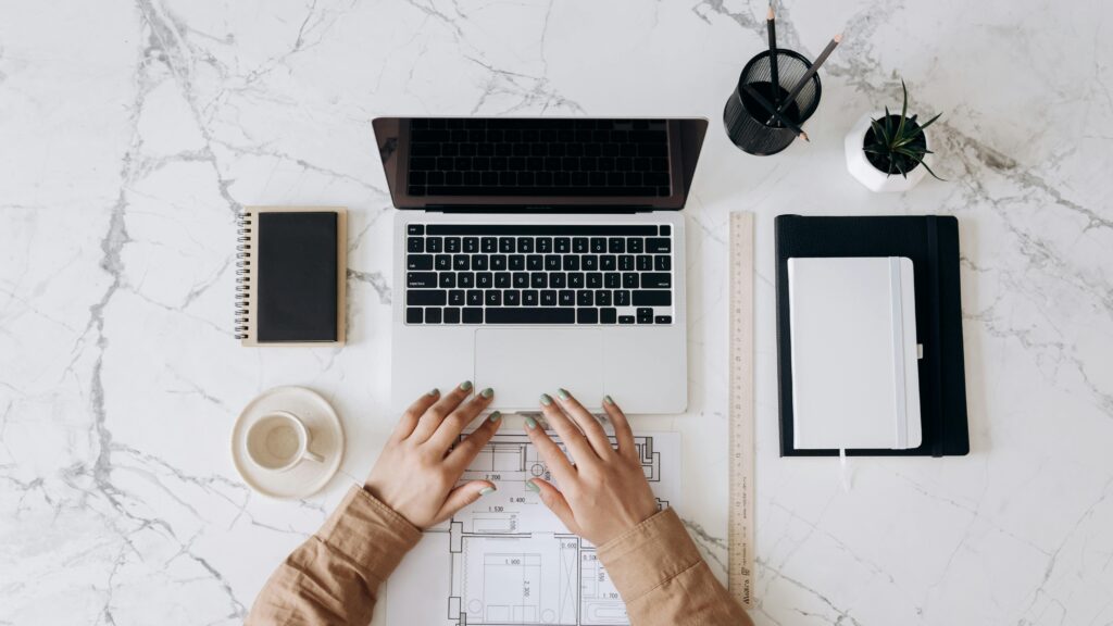 Creative entrepreneur planning a lead magnet and email funnel on laptop